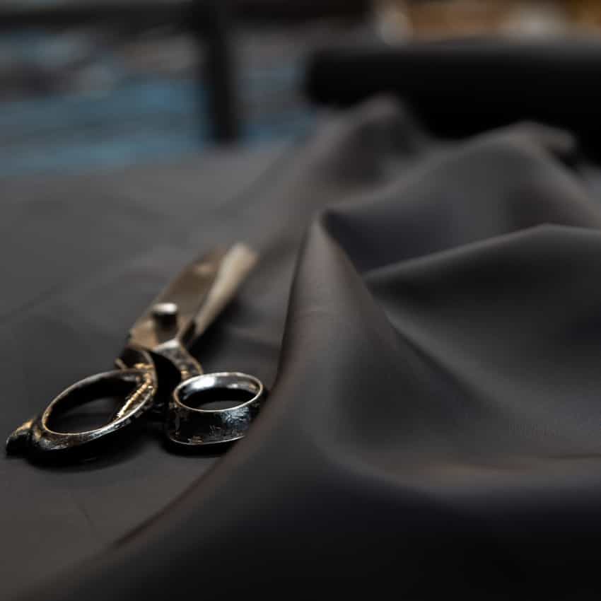 Black nylon fabric with scissors laid on top.