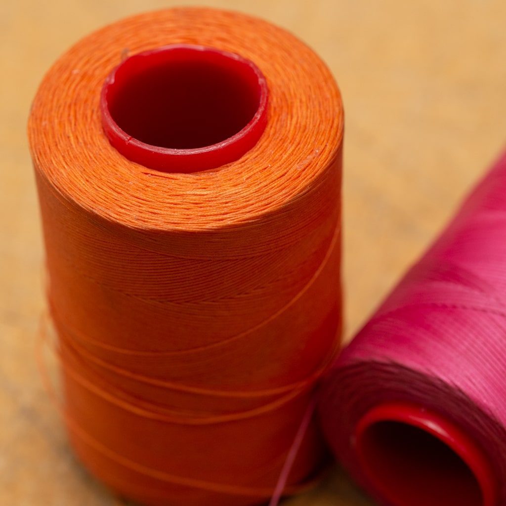 Spool of orange and pink thread