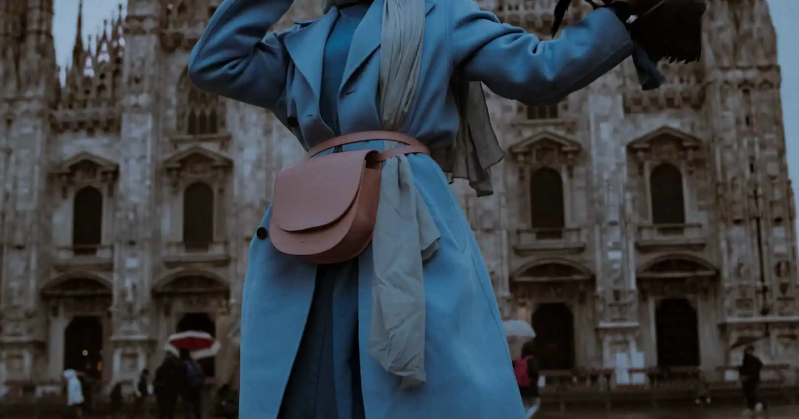 pink leather bag and blue coat