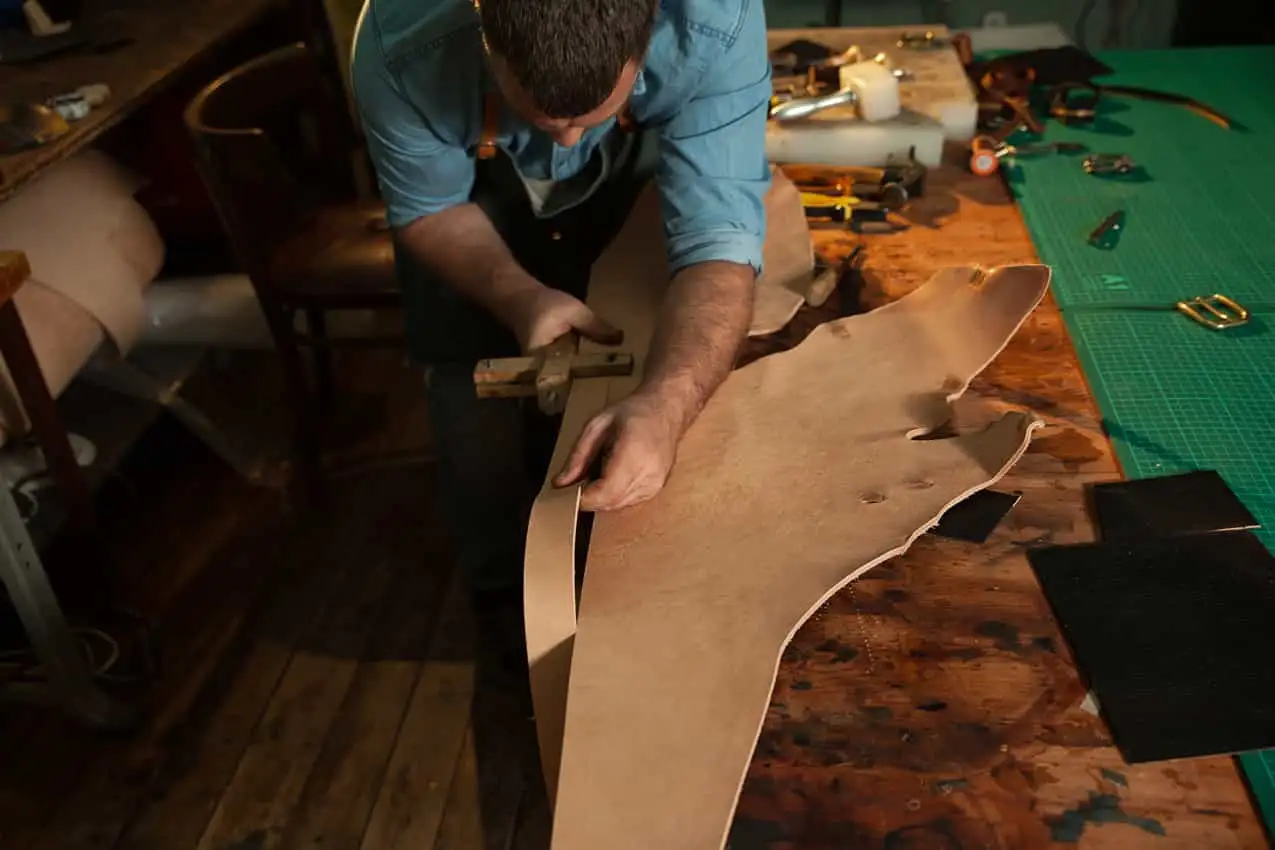 Man cutting strips for film/ theatre costume