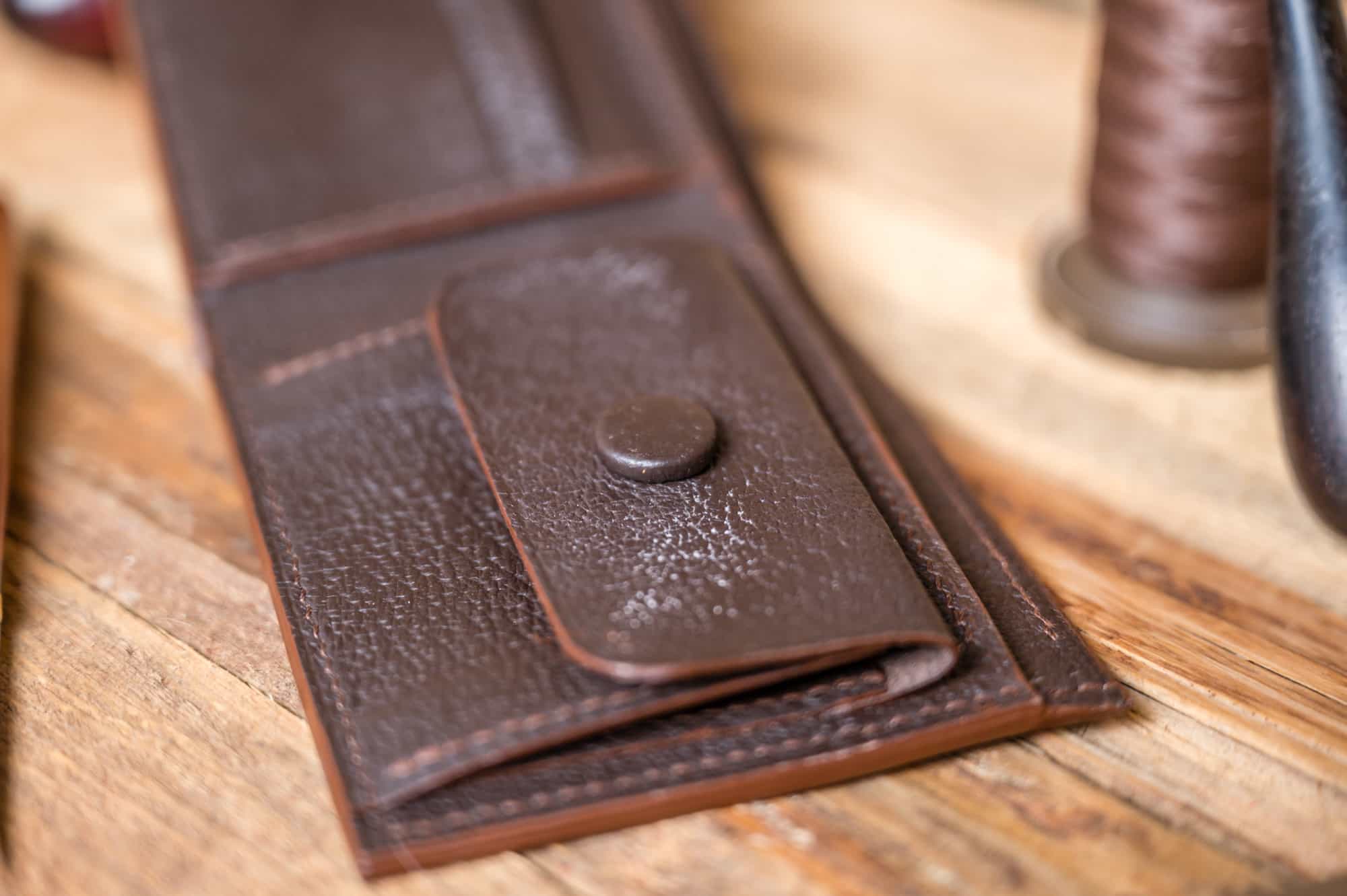 J H Bifold wallet on a table