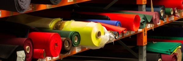 Colourful textile rolls on a shelf